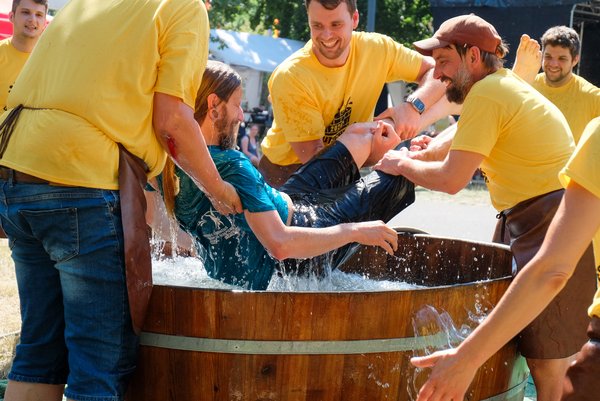Das Eintauchen der Kornuten Dem Kornuten wird an diesem heißen Sommertag eine Abkühlung verpasst: Die Gehilfen tauchen die Kornuten 3 bis 5 Mal in ein Wasserfass.